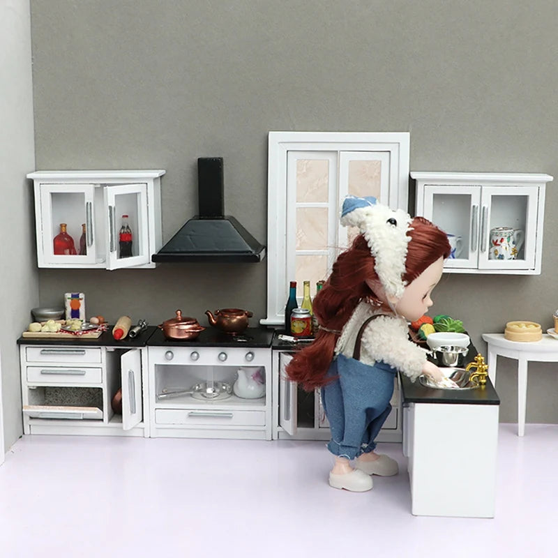 Modern 1:12 dollhouse kitchen set with miniature cabinets, stove, and accessories, featuring a doll in a cozy kitchen scene.