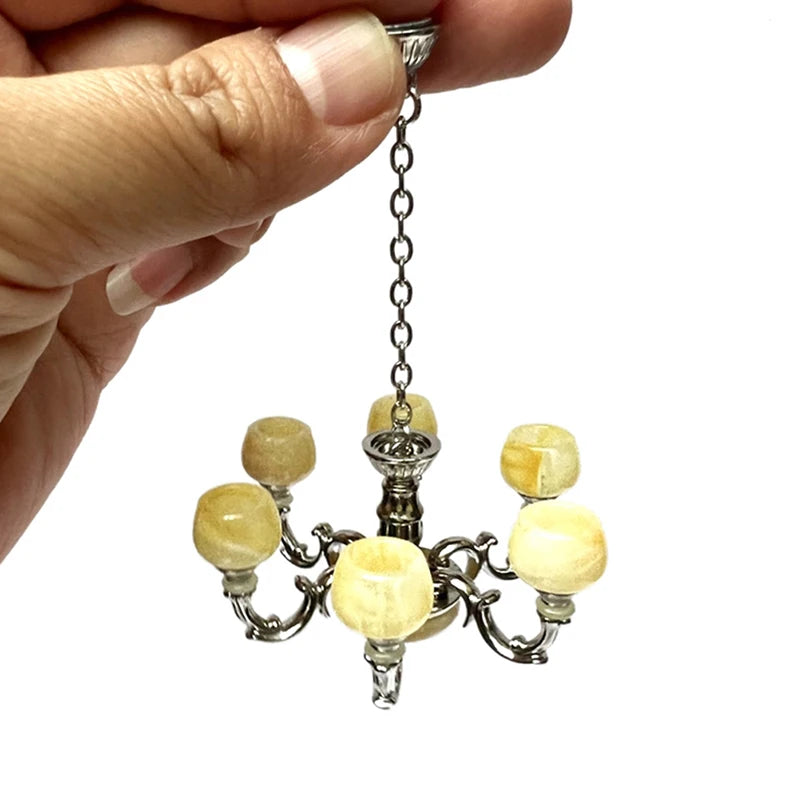 Elegant 1:12 dollhouse chandelier with six amber lights, perfect for miniature room decor and lighting ambiance.