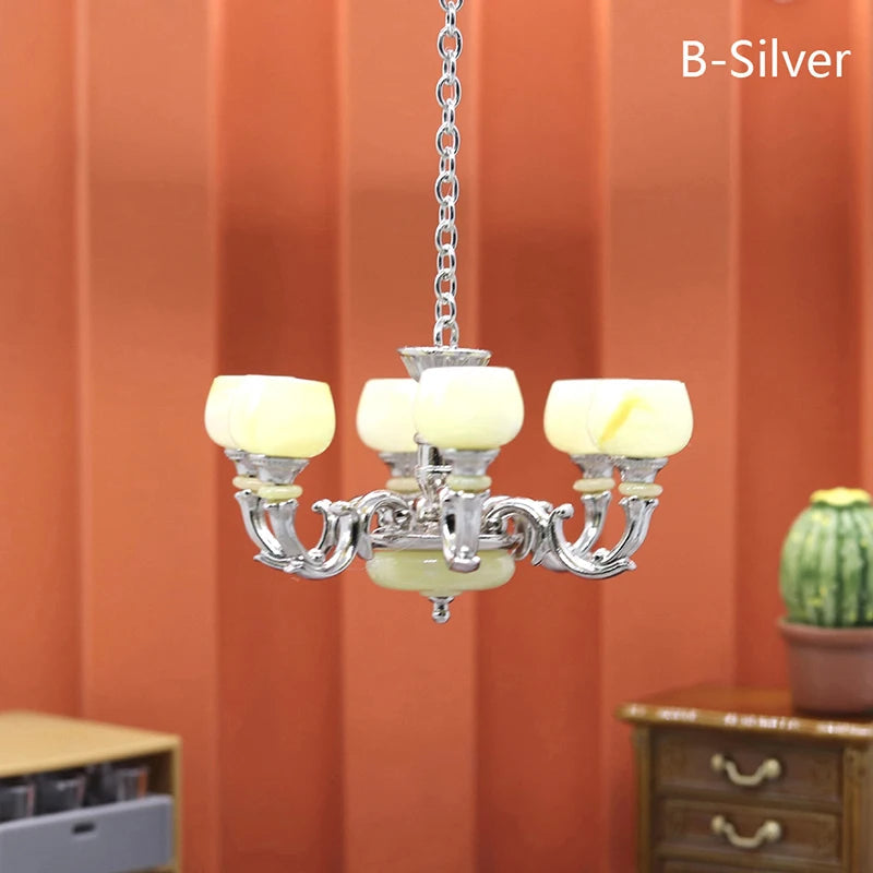 Elegant 1:12 dollhouse silver chandelier with cream shades, perfect for miniature home decor and lighting.