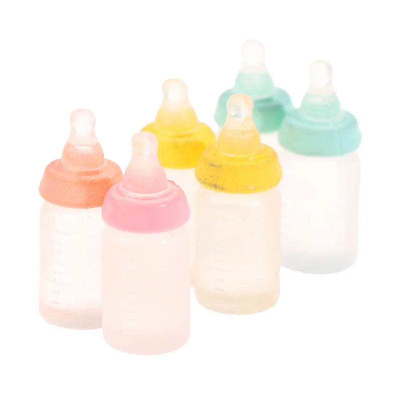 Miniature baby bottle set in pastel colors for dollhouses, perfect for enhancing baby doll nursery scenes.
