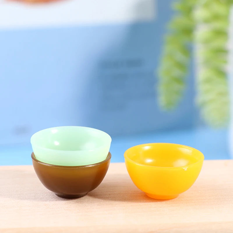 Miniature dollhouse round bowl set in pastel green, brown, and yellow, perfect for dollhouse kitchen decor.