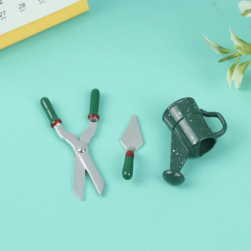 Miniature gardening tool set featuring green-handled shears, trowel, and a watering can on a turquoise background.