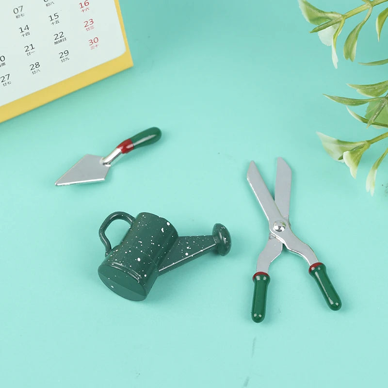 Miniature gardening tool set with a tiny watering can, trowel, and pruning shears on a mint green background.
