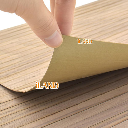 Hand peeling back iLAND dollhouse flooring, showcasing classic walnut texture for 1:12 and 1:6 scale models, 17"x11".