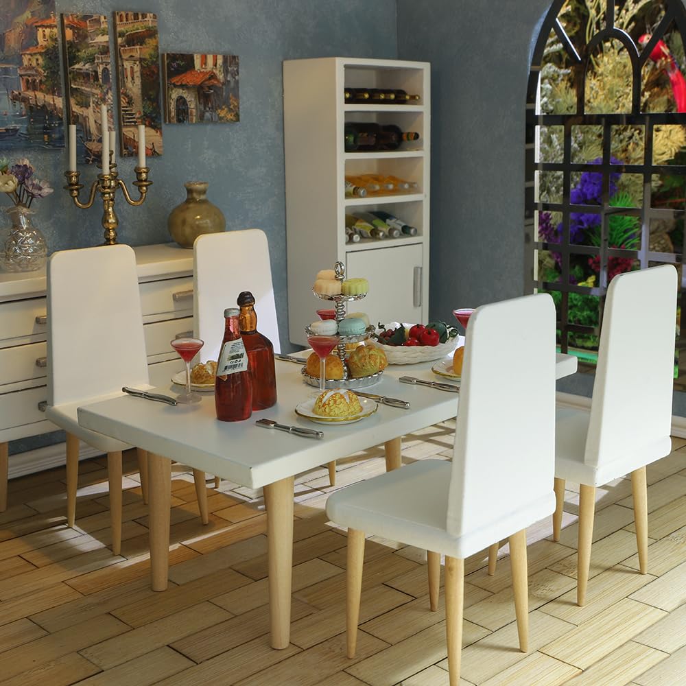 Modern 1/12 scale dollhouse kitchen with white wooden furniture, dining table set with miniature food and beverages.
