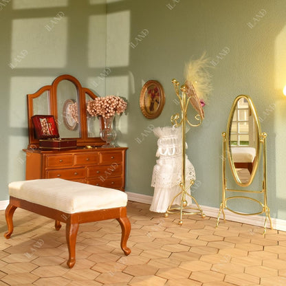 Miniature 1:12 scale dollhouse scene featuring a golden coat rack and full mirror, enhancing elegance and detail.