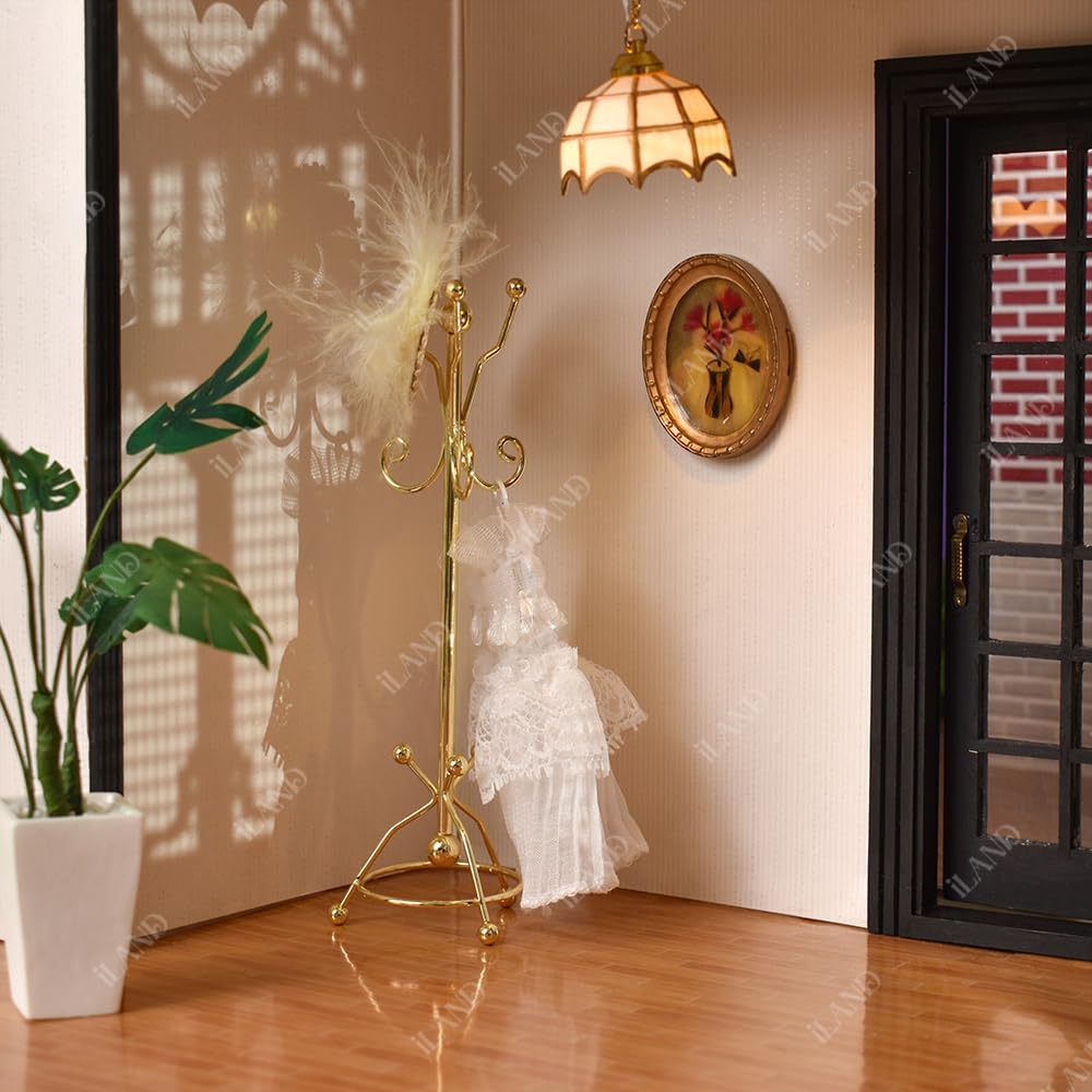 Miniature golden coat rack in 1:12 scale dollhouse, elegantly placed beside a decorative mirror.