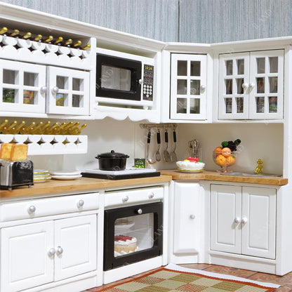 Modern 1/12 scale white dollhouse kitchen with wooden accents, featuring miniature appliances and storage for tiny food.