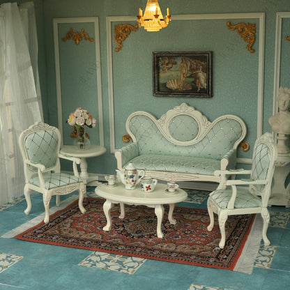 Victorian dollhouse furniture set with elegant sofa, armchairs, and tea set on ornate rug, ideal for miniature décor.