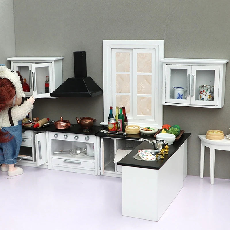 Modern 1:12 dollhouse kitchen set with stove, cabinets, and island, featuring miniature cookware and accessories.