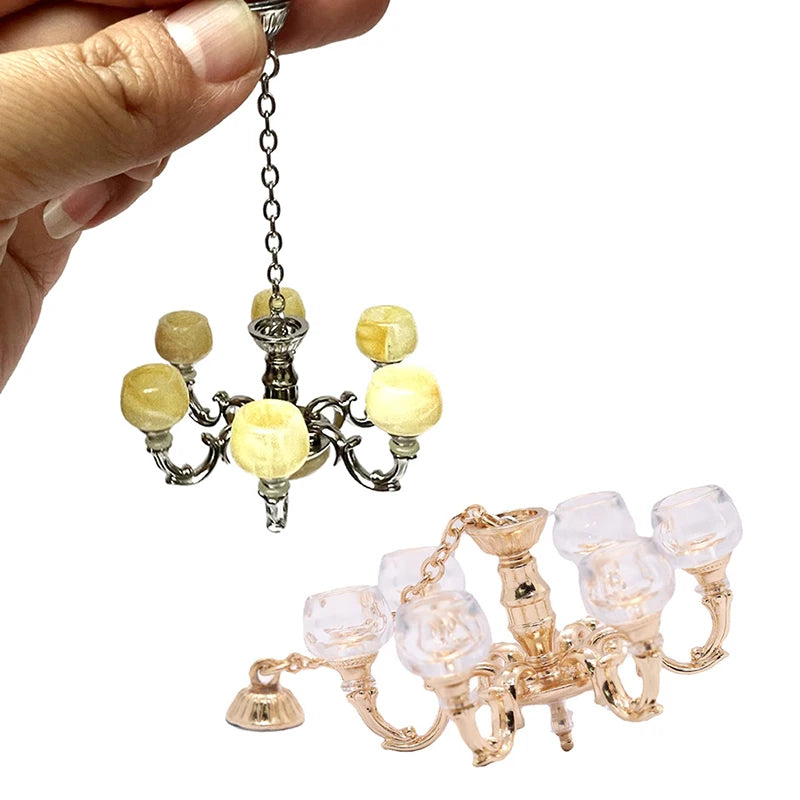 Elegant 1:12 dollhouse chandelier with golden and silver finishes, featuring intricate details and mini glass lampshades.