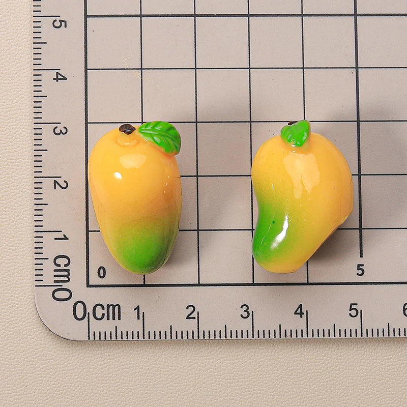 Miniature resin mangoes for 1:12 dollhouse, detailed and vibrant, perfect for miniature fruit displays and dollhouse decor.