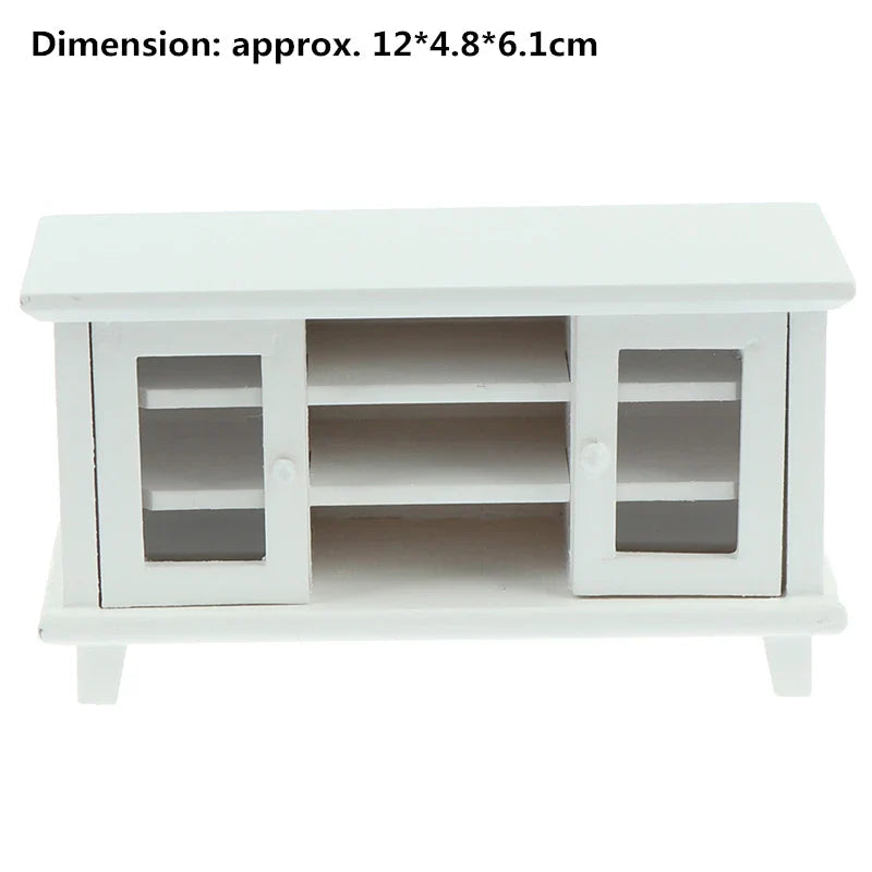 White wooden miniature TV stand in 1:12 scale, featuring glass doors and shelves, perfect for dollhouse living rooms.